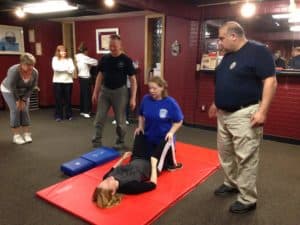 Police Academy Instructor Phil Abdoo with Al Polkowski assisting the Women’s Self-Defense Class