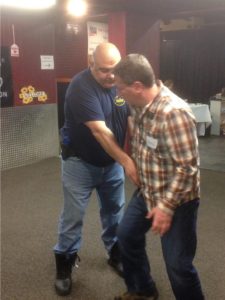 Police Academy Instructor Phil Abdoo assists a student in proper handgun retention techniques